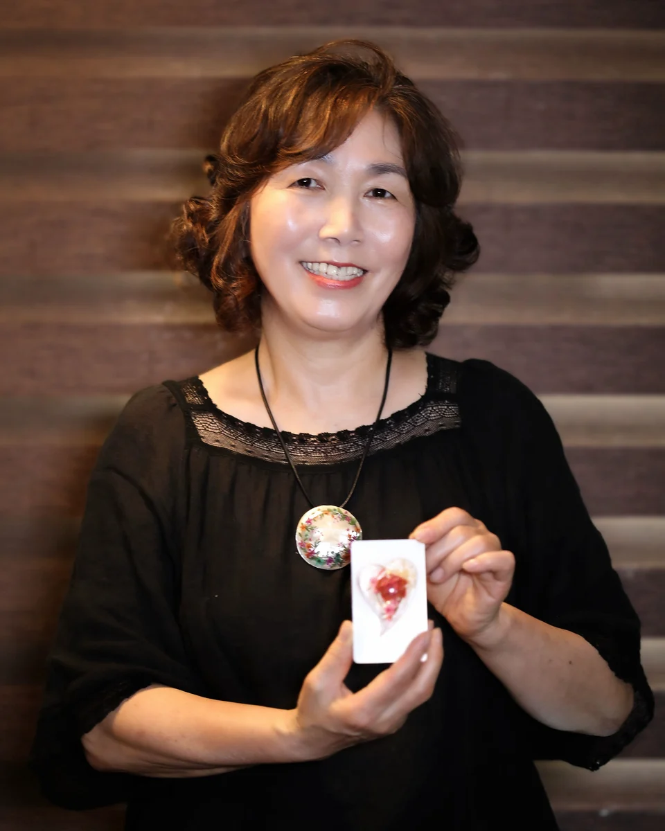 압화 카드를 들고 웃는 이경숙 작가